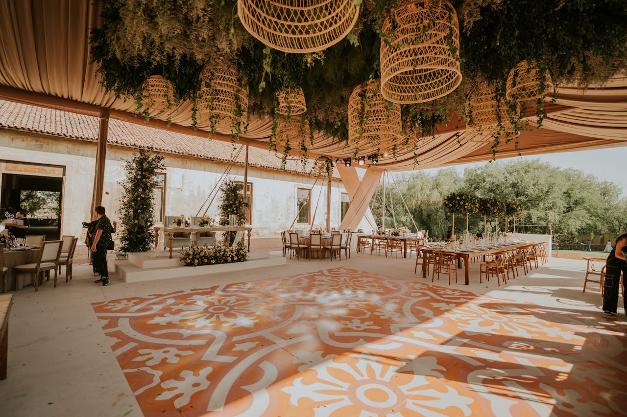 A wedding reception with a large orange and white floor